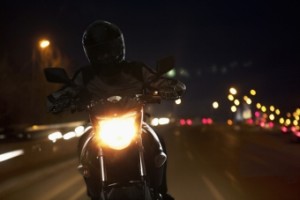 Young Man riding motorcycle at night