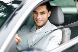 Handsome man fastening seat belt